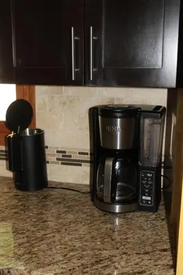 a microwave and a coffee maker on a kitchen counter at Family Friendly lodge located in the Hocking Hills in Rockbridge