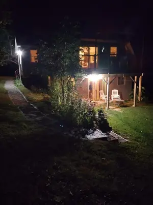 a house at night with lights in the yard at Country suite with bath and laundry in Athens