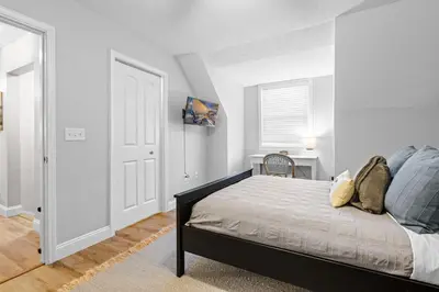 a bedroom with a bed and a table and a window at Cedar Point, Kalahari, Sports Force, Hot tub, Fire pit, EV, Pets, Beach, Fireplace, Park in Huron