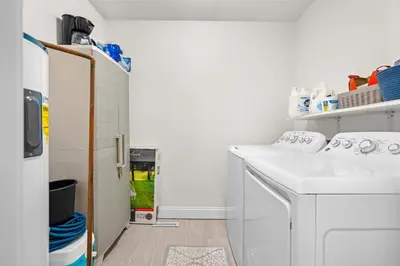a white laundry room with a sink and a counter at Cedar Point, Kalahari, Sports Force, Hot tub, Fire pit, EV, Pets, Beach, Fireplace, Park in Huron