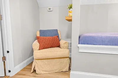 a chair with a pillow in a room at Cedar Point, Kalahari, Sports Force, Hot tub, Fire pit, EV, Pets, Beach, Fireplace, Park in Huron