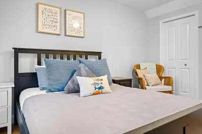 a bedroom with a large bed with blue pillows at Cedar Point, Kalahari, Sports Force, Hot tub, Fire pit, EV, Pets, Beach, Fireplace, Park in Huron