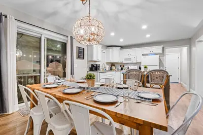 a kitchen and dining room with a wooden table and chairs at Cedar Point, Kalahari, Sports Force, Hot tub, Fire pit, EV, Pets, Beach, Fireplace, Park in Huron