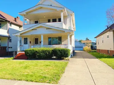 a house on a street with a sidewalk at Cozy room in 2nd floor - near Airport & Lakewood in Cleveland