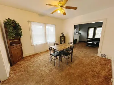a dining room with a table and chairs and a ceiling fan at Cozy room in 2nd floor - near Airport & Lakewood in Cleveland