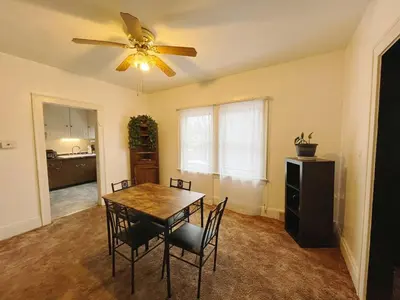 a dining room with a table and chairs and a ceiling fan at Cozy room in 2nd floor - near Airport & Lakewood in Cleveland