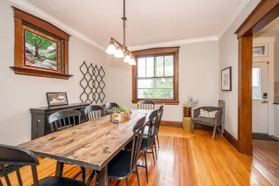 a dining room with a wooden table and chairs at Doctors Retreat with Hot Tub in Dayton