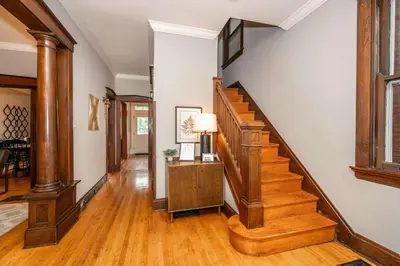a hallway with wooden stairs in a home at Doctors Retreat with Hot Tub in Dayton