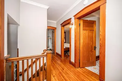 a hallway with a wooden door leading to a bedroom at Doctors Retreat with Hot Tub in Dayton