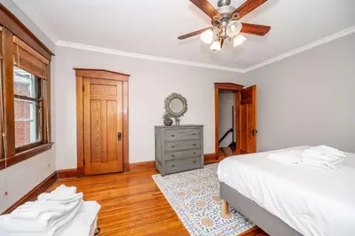 a bedroom with a bed and a ceiling fan at Doctors Retreat with Hot Tub in Dayton