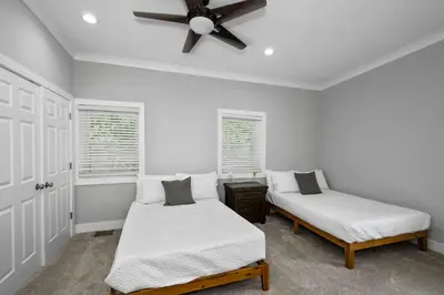 a bedroom with two beds and a ceiling fan at Cincy Comfort Retreat in Cincinnati