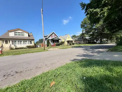 an empty street in a residential neighborhood with houses at Super close to Cleveland Clinic Fairview Colibri in Cleveland