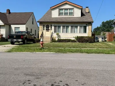 a house with a fire hydrant in front of a house at Super close to Cleveland Clinic Fairview Colibri in Cleveland