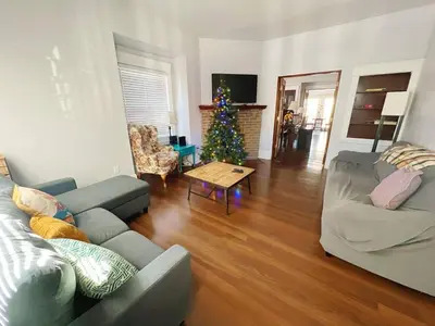 a living room with a christmas tree and a couch at Deux Private Room 11 mins to Downtown & 15 minutes to Cleveland Airport in Cleveland