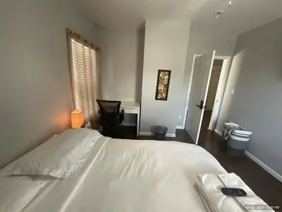 a bedroom with a white bed and a window at Deux Private Room 11 mins to Downtown & 15 minutes to Cleveland Airport in Cleveland