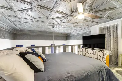 a bedroom with a bed and a flat screen tv at 7 Mi to Dtwn Charming Couples Cove in Cincinnati in Cincinnati