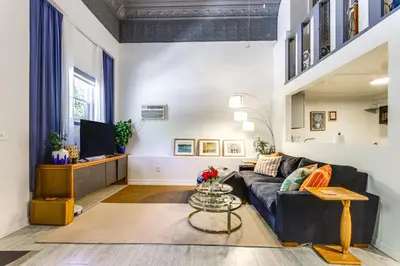 a living room with a couch and a tv at 7 Mi to Dtwn Charming Couples Cove in Cincinnati in Cincinnati