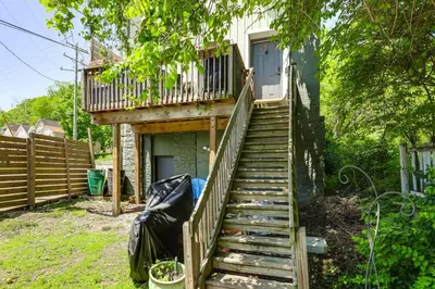 a staircase leading up to a house with a porch at 7 Mi to Dtwn Charming Couples Cove in Cincinnati in Cincinnati