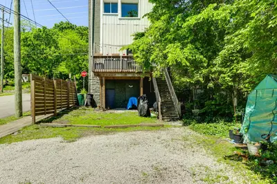 a house with a fence and a staircase in the yard at 7 Mi to Dtwn Charming Couples Cove in Cincinnati in Cincinnati