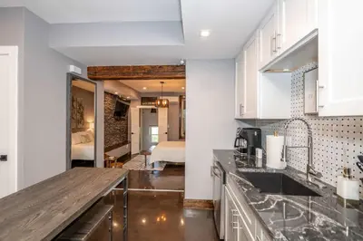 a kitchen with white cabinets and a counter top at Luxury Mt Adams Retreat Apt 1 in Cincinnati