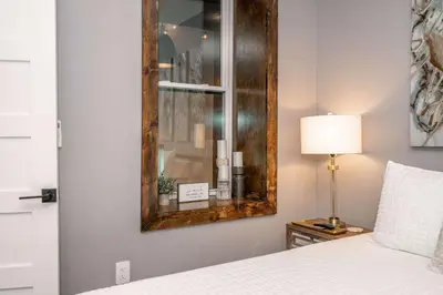 a bedroom with a mirror and a bed at Luxury Mt Adams Retreat Apt 1 in Cincinnati