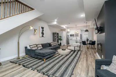 a living room with a couch and a table at Lee Street Lodge - Minutes from DT in Covington