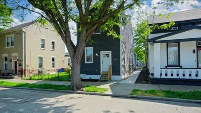 a street with two houses and a tree at Lee Street Lodge - Minutes from DT in Covington