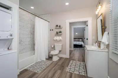 a bathroom with a toilet and a shower and a sink at Lee Street Lodge - Minutes from DT in Covington