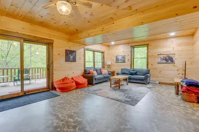 a living room with couches and chairs in a cabin at 15 Mi to Hocking Hills Secluded Cabin with Hot Tub in Logan