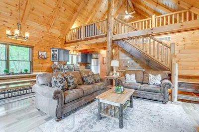 a living room with two couches and a table at 15 Mi to Hocking Hills Secluded Cabin with Hot Tub in Logan