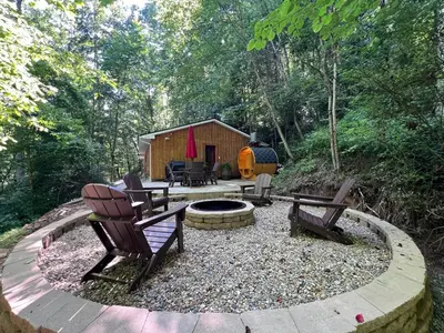 a backyard with chairs and a fire pit and a cabin at Burton Ridge Cabin in South Bloomingville