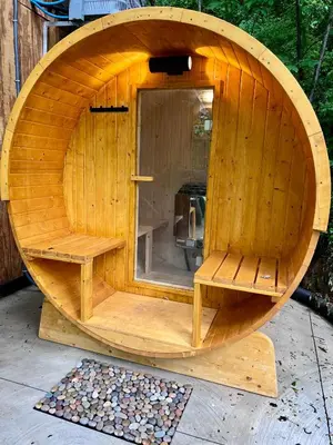a small wooden sauna with a bench in it at Burton Ridge Cabin in South Bloomingville