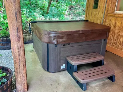 a large dog house with a stool next to it at Burton Ridge Cabin in South Bloomingville