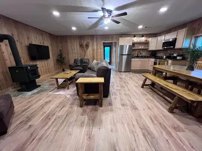 a living room with a couch and a table at Burton Ridge Cabin in South Bloomingville