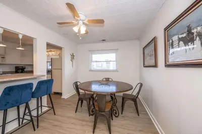 a dining room and kitchen with a table and chairs at The Grand Elm Suites in Ludlow