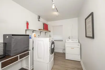 a laundry room with a washer and dryer in it at The Grand Elm Suite 1 - Sleeps 4 in Ludlow