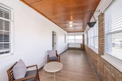 a hallway with a table and chairs and windows at The Grand Elm Suite 1 - Sleeps 4 in Ludlow