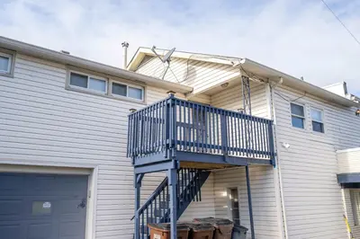 a house with a blue staircase in front of it at The Grand Elm Suite 2 in Ludlow