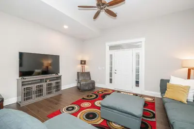 a living room with a couch and a flat screen tv at Sweet Escape in Cincinnati