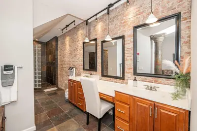a bathroom with a sink and two mirrors at Sweet Escape in Cincinnati