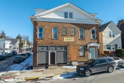 a brick house with a car parked in front of it at Sweet Escape in Cincinnati