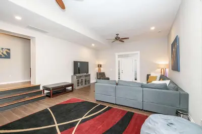 a living room with a couch and a tv at Sweet Escape in Cincinnati
