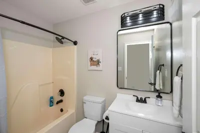 a bathroom with a toilet and a sink and a mirror at The Restful Ark in Crittenden