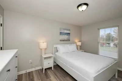 a bedroom with a white bed and a window at The Restful Ark in Crittenden