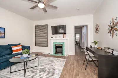 a living room with a blue couch and a fireplace at Historic Ludlow Suites - 2 Apts in Ludlow