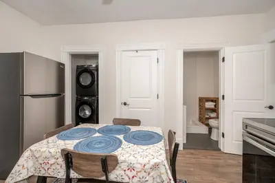 a dining room with a table and a kitchen at Historic Ludlow Suites - 2 Apts in Ludlow