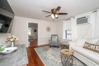 a living room with a couch and a ceiling fan at Historic Ludlow Suites - 2 Apts in Ludlow