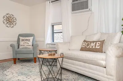 a living room with a couch and a chair at Historic Ludlow Suites - 2 Apts in Ludlow