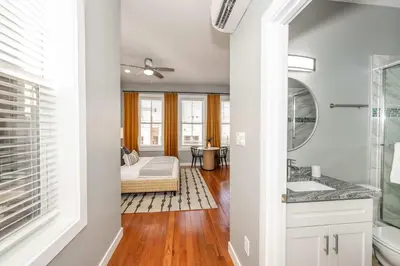 a bathroom with a sink and a bed in a room at Findlay Market - Suite 4 for 2 in Cincinnati