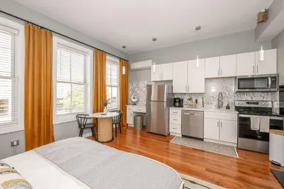 a kitchen with white cabinets and stainless steel appliances at Findlay Market - Suite 4 for 2 in Cincinnati